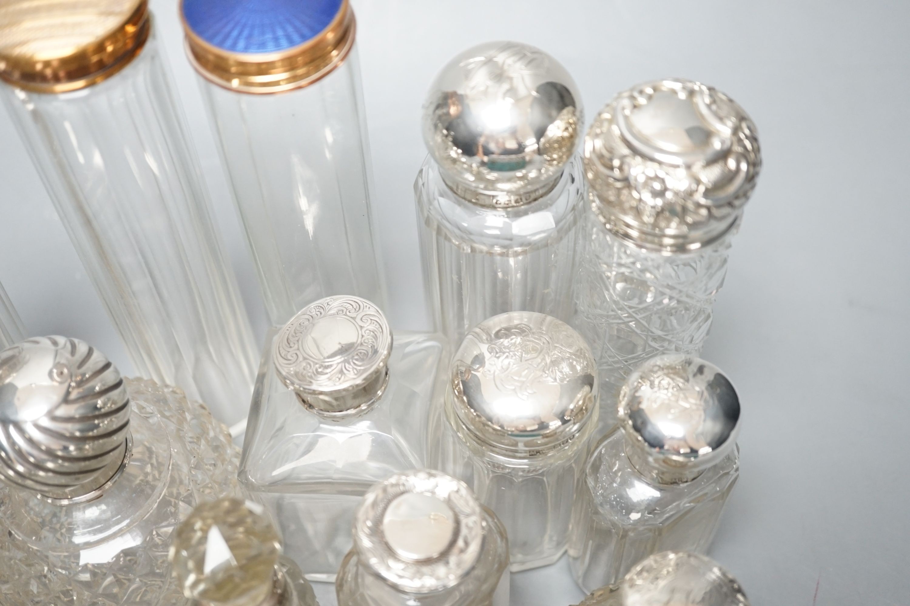 A collection of assorted mainly silver-capped scent bottles and toilet bottles.